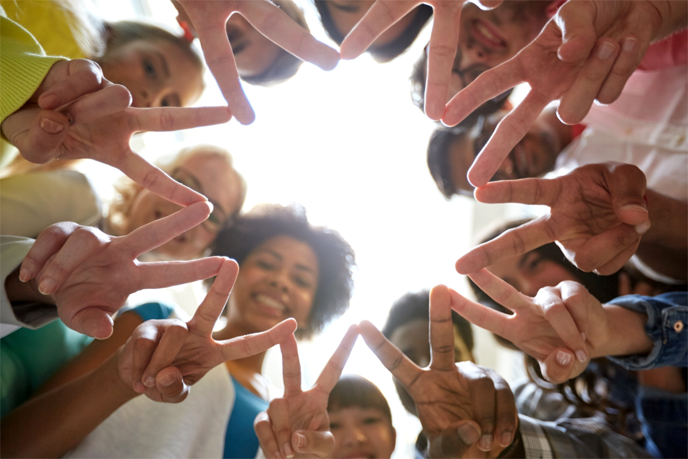 education, friendship, gesture, victory and people concept - group of happy international students or friends standing in circle and showing peace or v sign